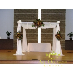 Iron square arch with white draping and flower